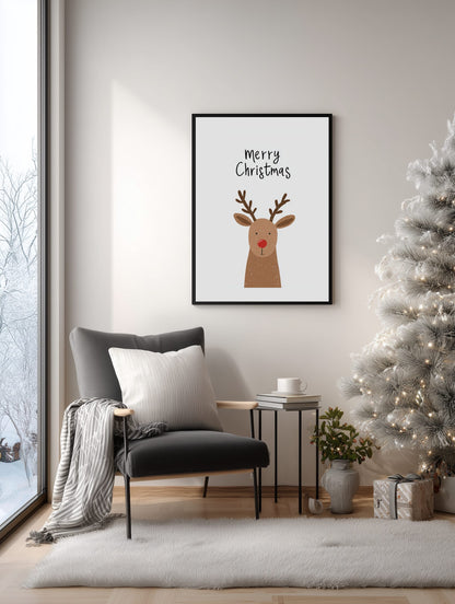Framed Christmas-themed print with a reindeer on a wall in a living room with a decorated tree.