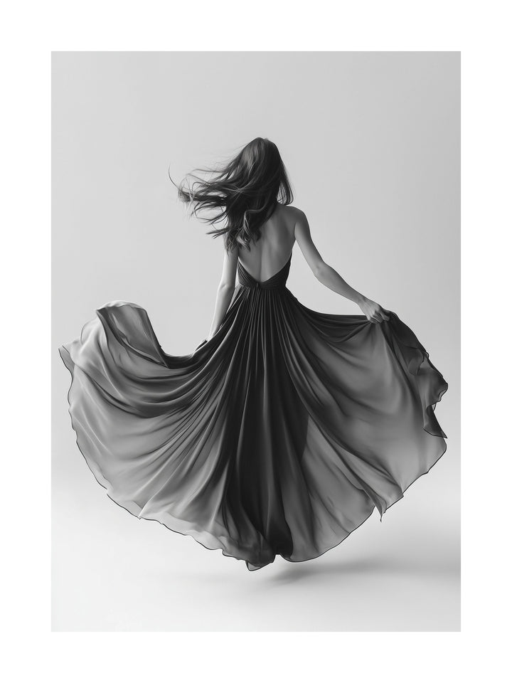 Woman in a flowing dress spinning in black and white