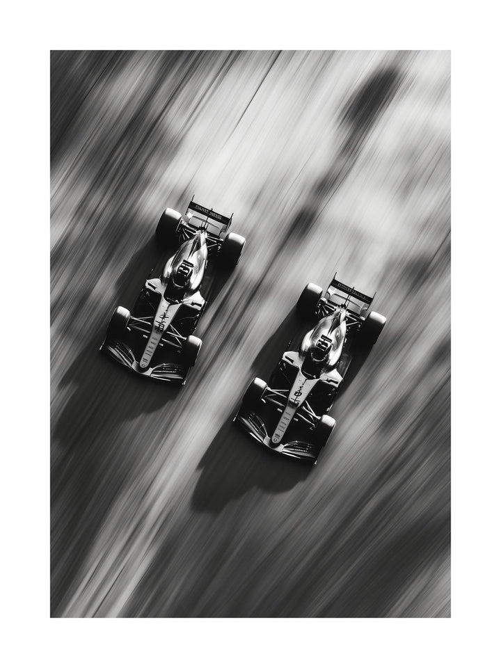 Black and white top-down image of two Formula 1 cars racing