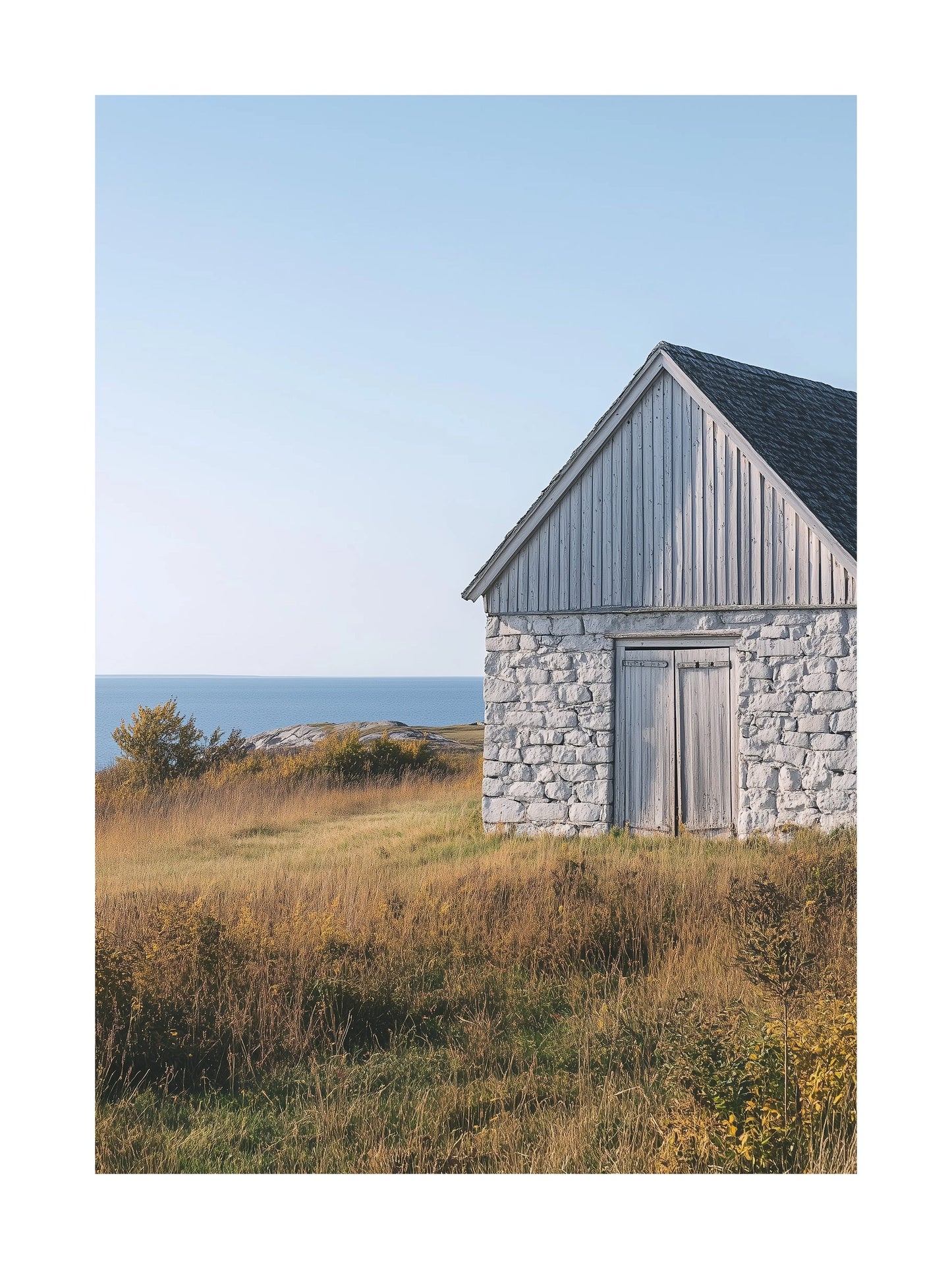 Poster of a weathered stone barn on Gotland with sea in the background