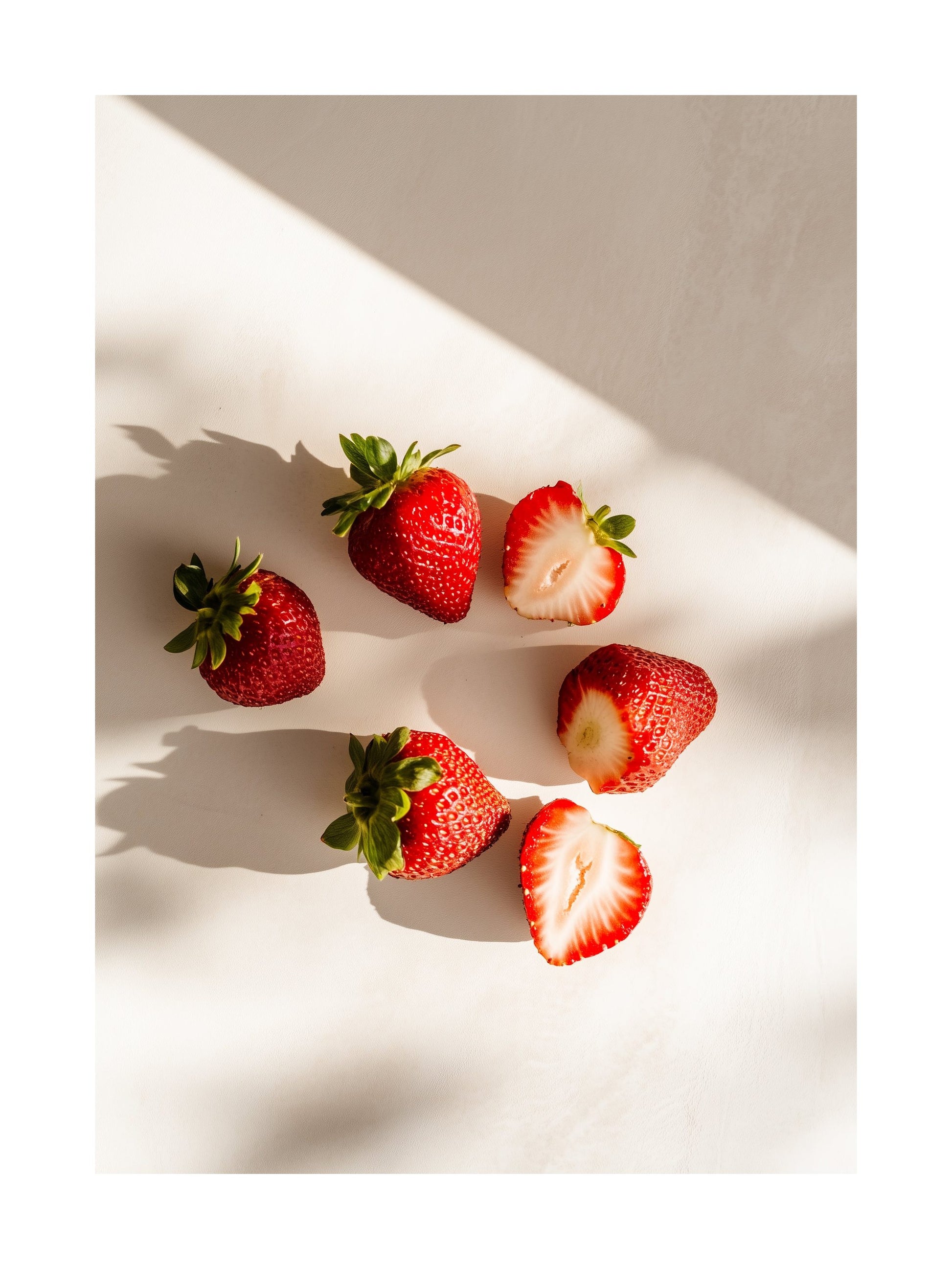 Poster of halved and whole strawberries casting shadows on white