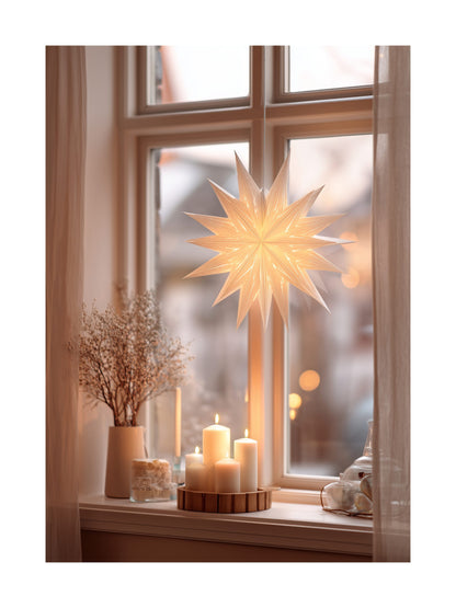 Scandinavian window with glowing paper star and lit candles on a cozy windowsill