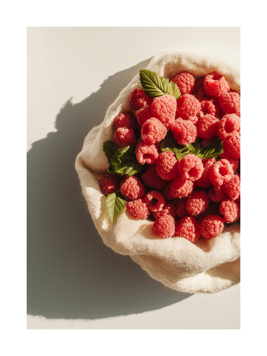 Poster of raspberries in a fabric bowl with soft shadows