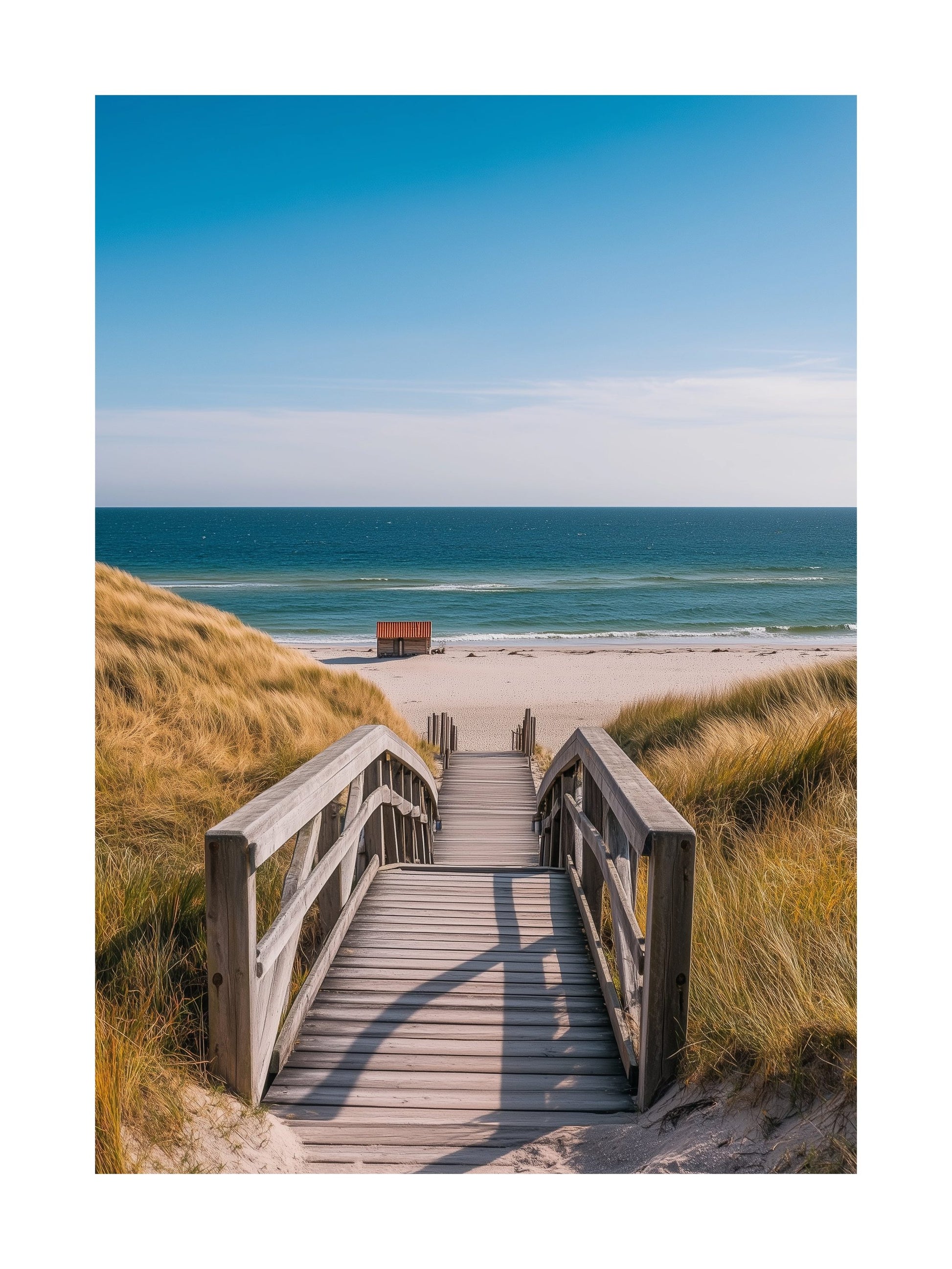 Wooden pathway to the beach with clear blue ocean and sand dunes