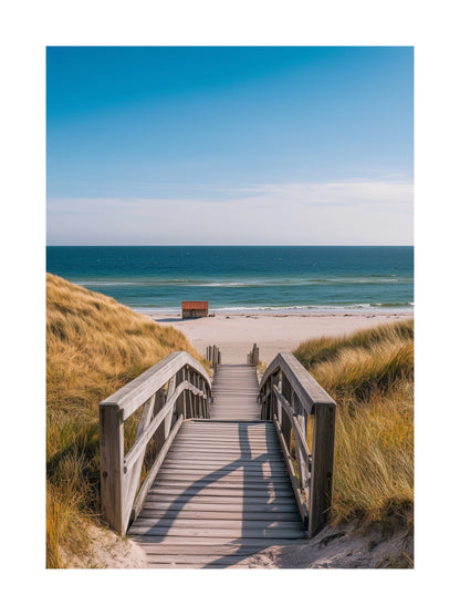 Wooden pathway to the beach with clear blue ocean and sand dunes