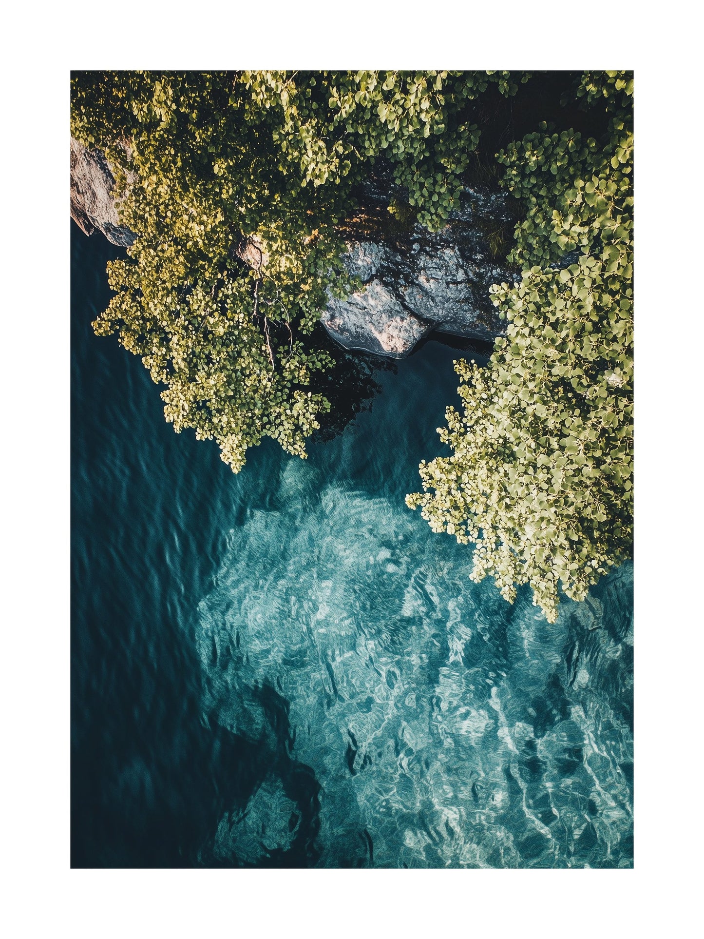 Overhead view of a clear fjord with rocky cliffs and green trees in Norway. Ideal for wall art in your home, office, or studio.
