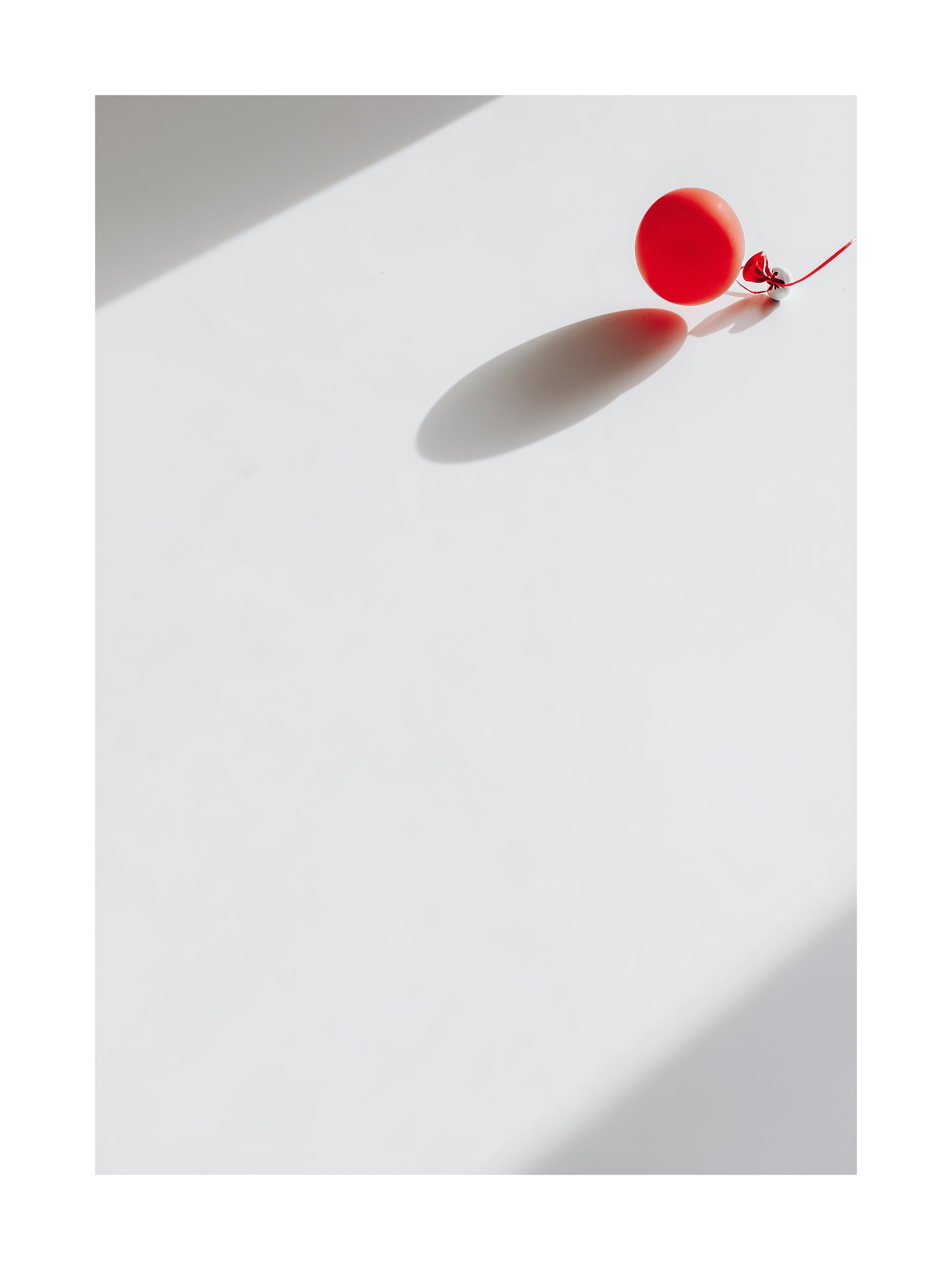 Minimalist Halloween poster of a red balloon with shadow on white background