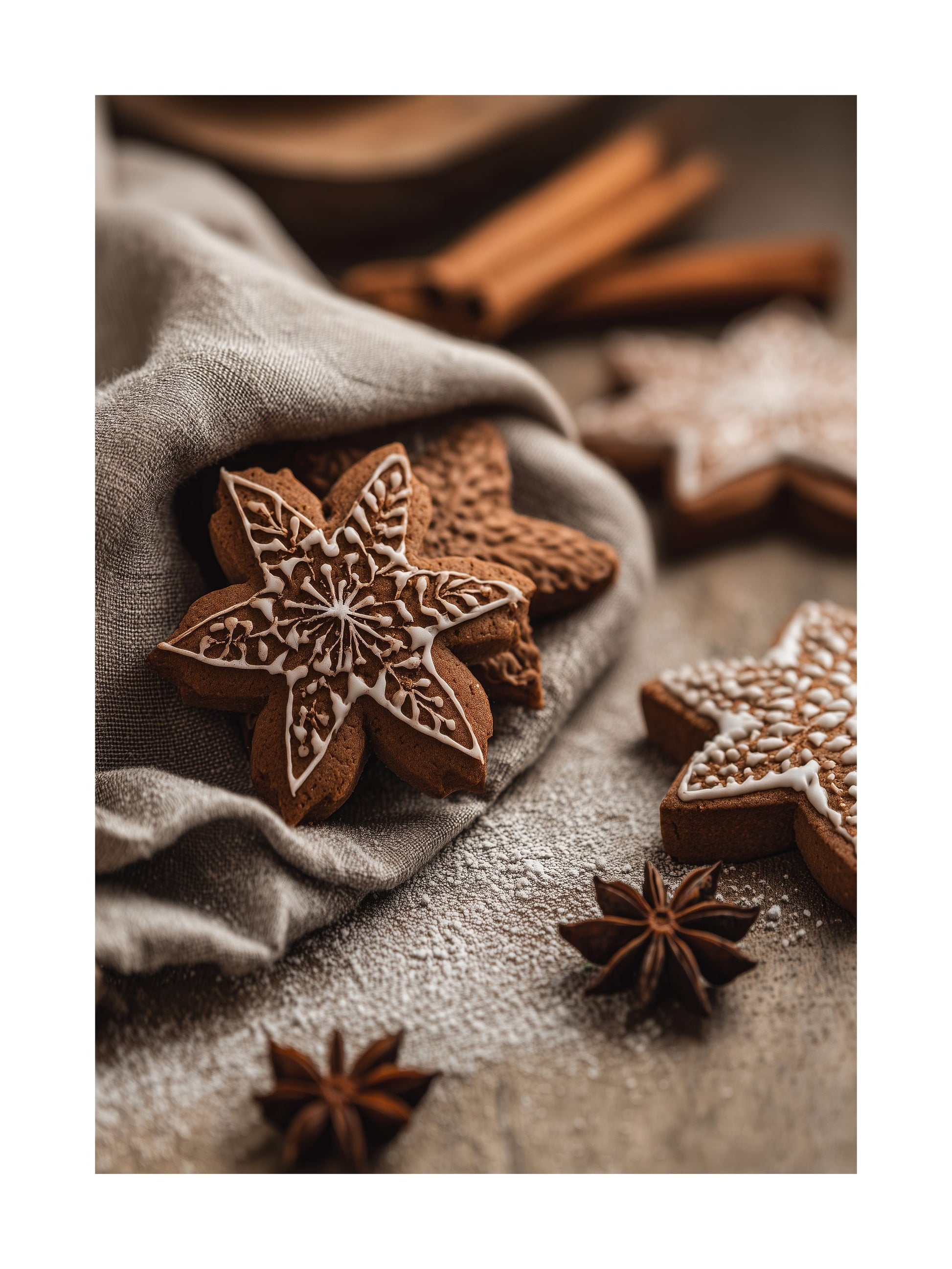 Detailed gingerbread star cookies with icing on linen cloth and cinnamon sticks
