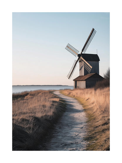 Old wooden windmill by the coast with sunset path on Gotland