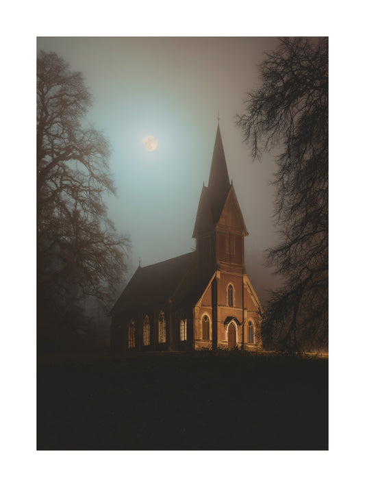 Haunted church in the moonlight with eerie fog and trees