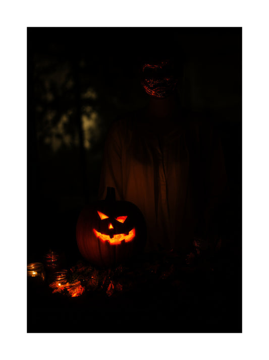 Poster of a glowing jack-o’-lantern with a masked figure in the dark